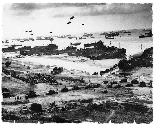 Thousands of troops, landing vehicles and cargo on a Normandy Beach 6 June 1944
